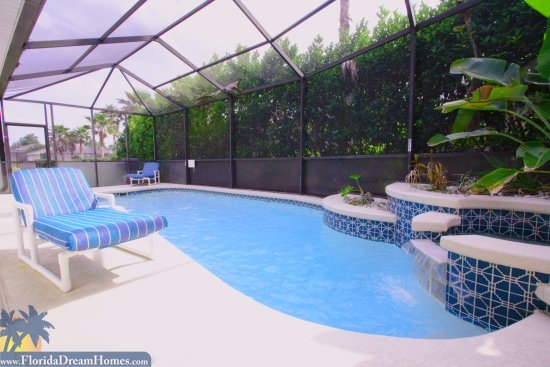 Tropical Landscaping Engulfs the Private Pool which Features a Fountain and Waterfall